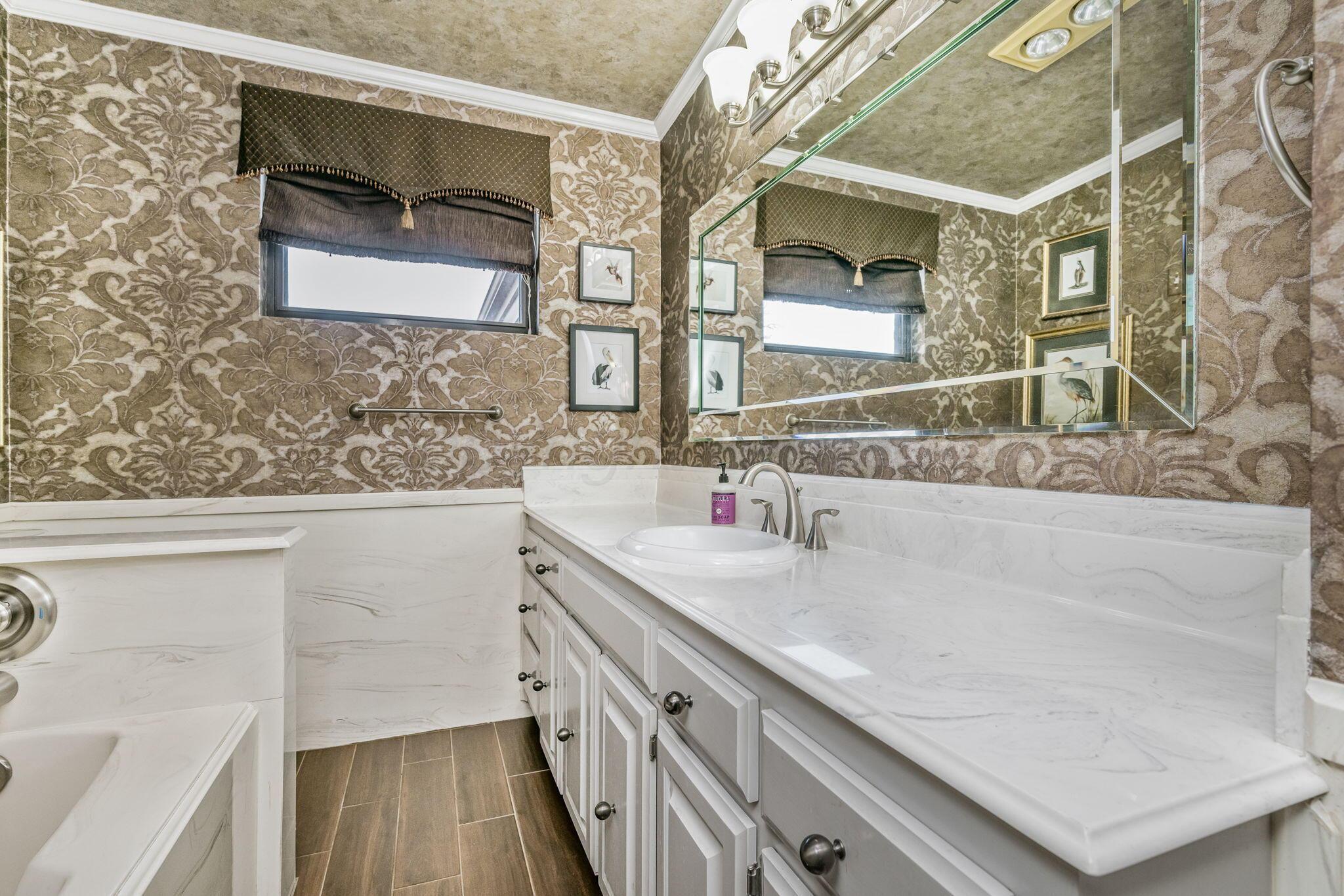 3603 Hancock Street Amarillo, TX 79109 - Photo 16 of 23 a bathroom with a sink and a mirror