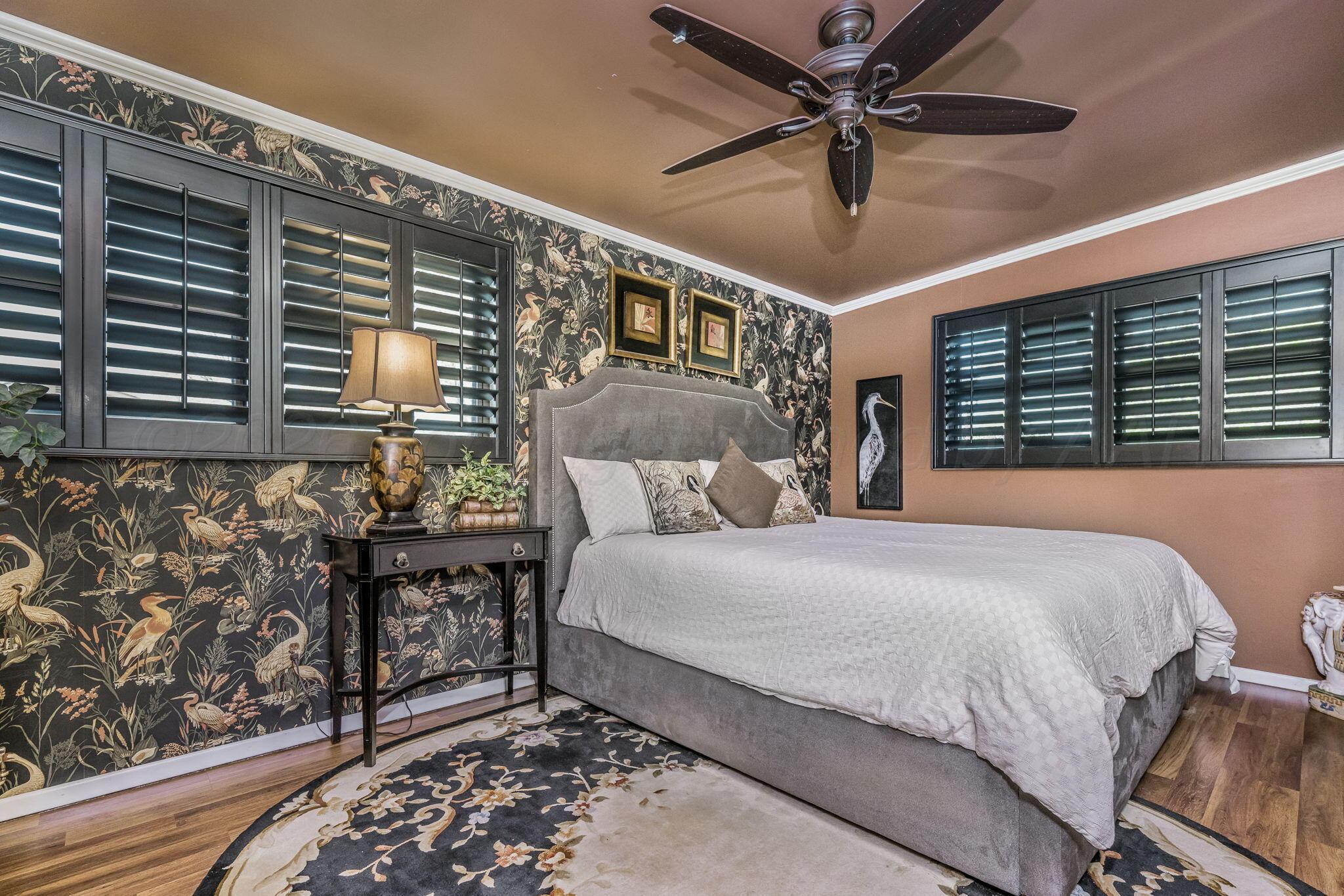 3603 Hancock Street Amarillo, TX 79109 - Photo 19 of 23 a bedroom with a bed and a chandelier