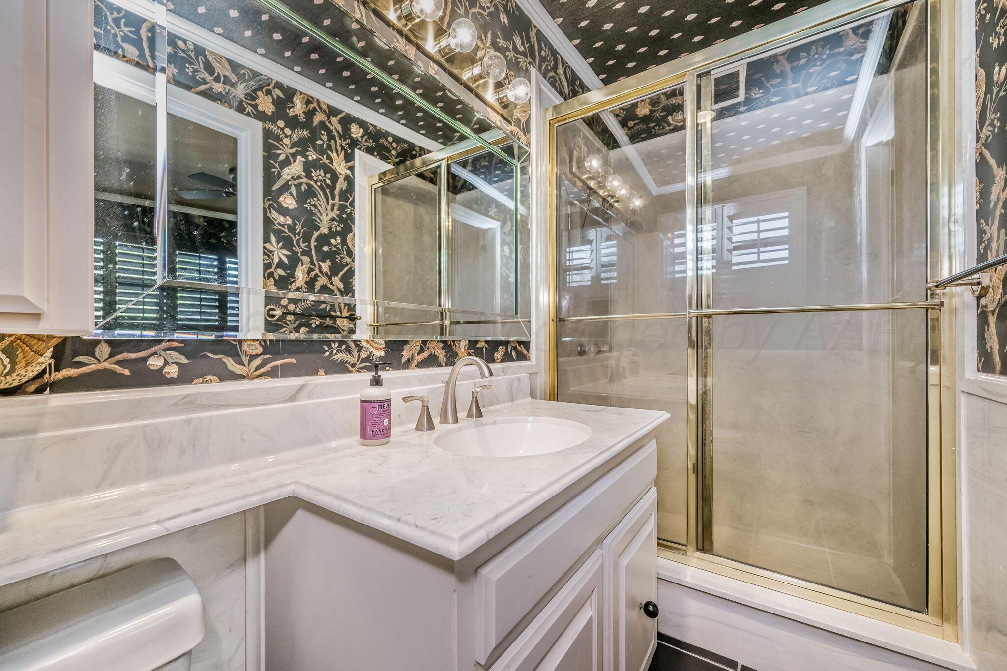 3603 Hancock Street Amarillo, TX 79109 - Photo 22 of 23 a bathroom with a sink and a mirror