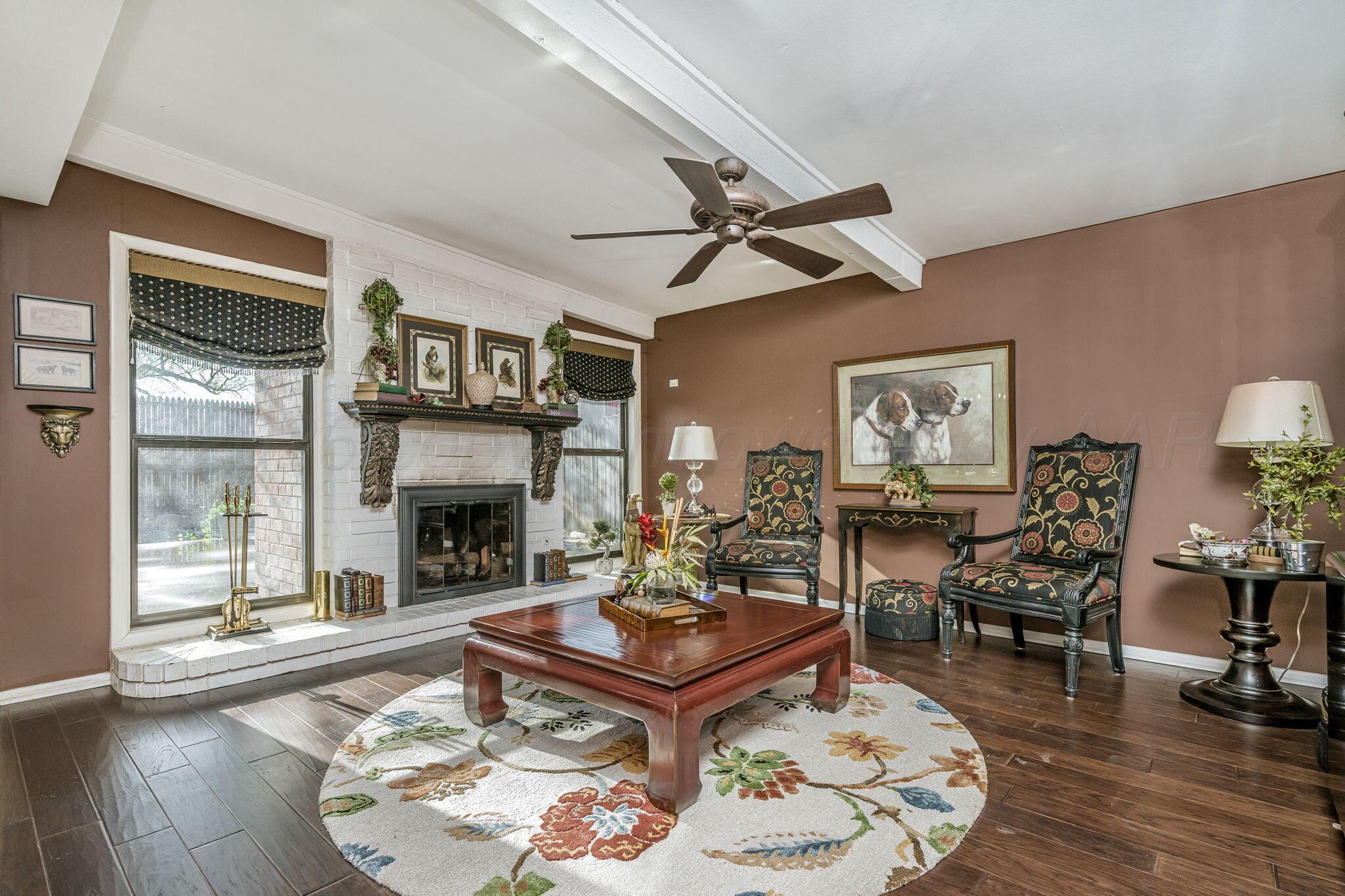 3603 Hancock Street Amarillo, TX 79109 - Photo 8 of 23 a living room with furniture a fireplace and a table