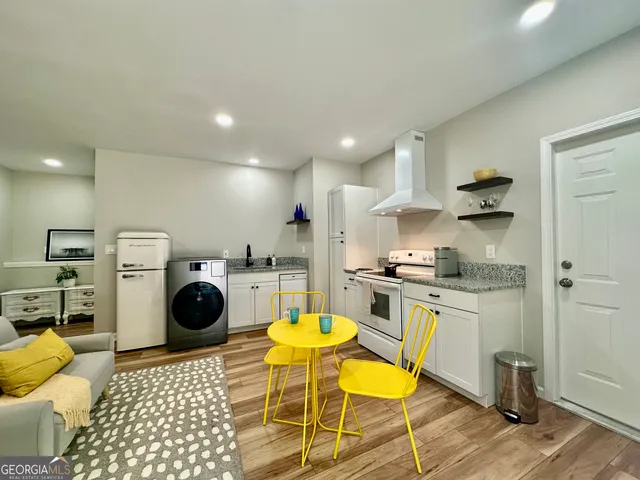a kitchen with a sink a stove and cabinets