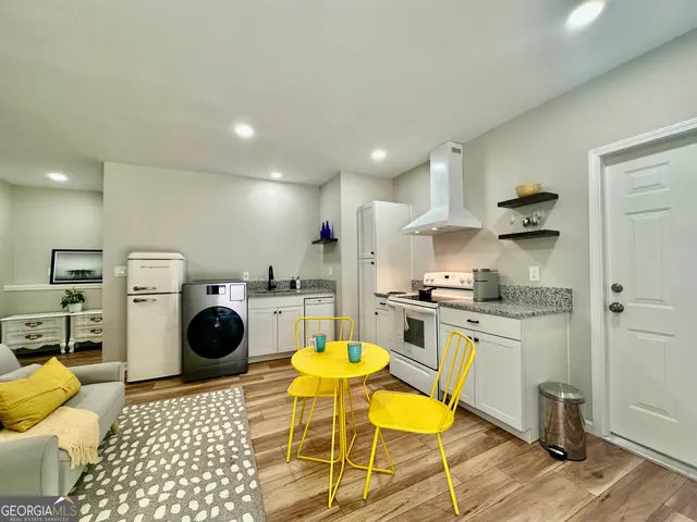 a kitchen with a sink a stove and cabinets