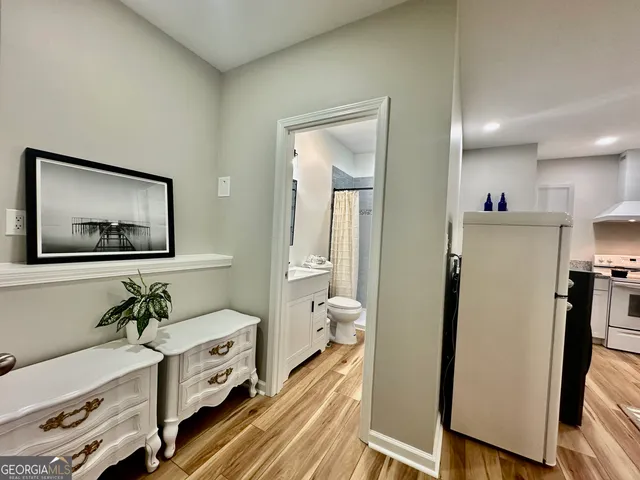 a view of a hallway with workspace and a window