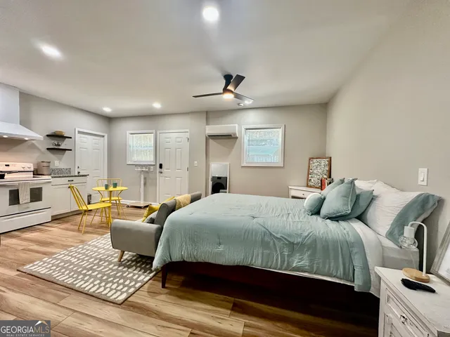 a bedroom with a bed a couch and dresser