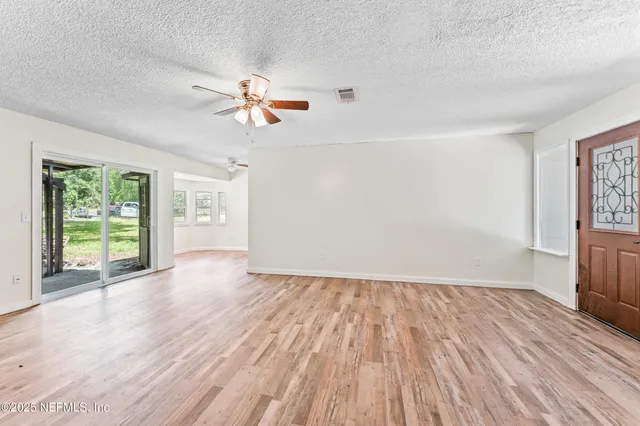 wooden floor in an empty room with a window