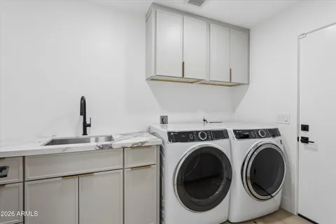a kitchen with cabinets and washer