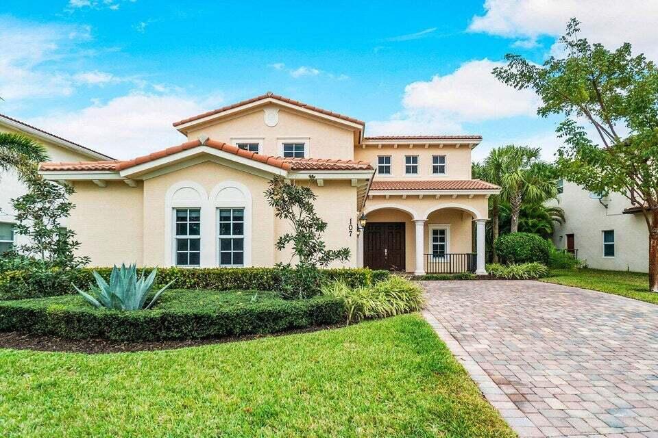 107 Chub Cay Way Jupiter, FL 33458 - Photo 2 of 15 a view of house with garden and tall tress
