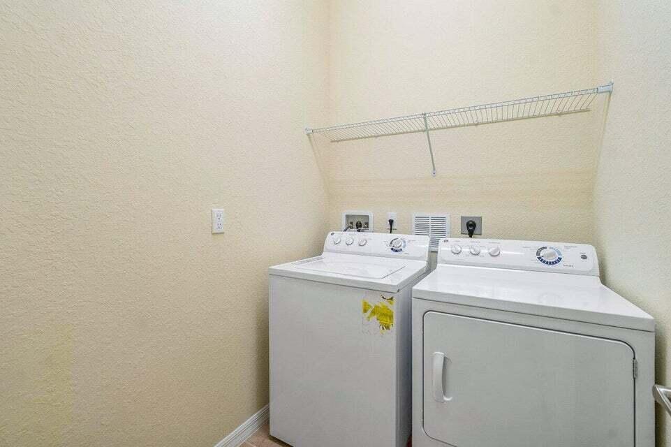 107 Chub Cay Way Jupiter, FL 33458 - Photo 10 of 15 a utility room with dryer and washer