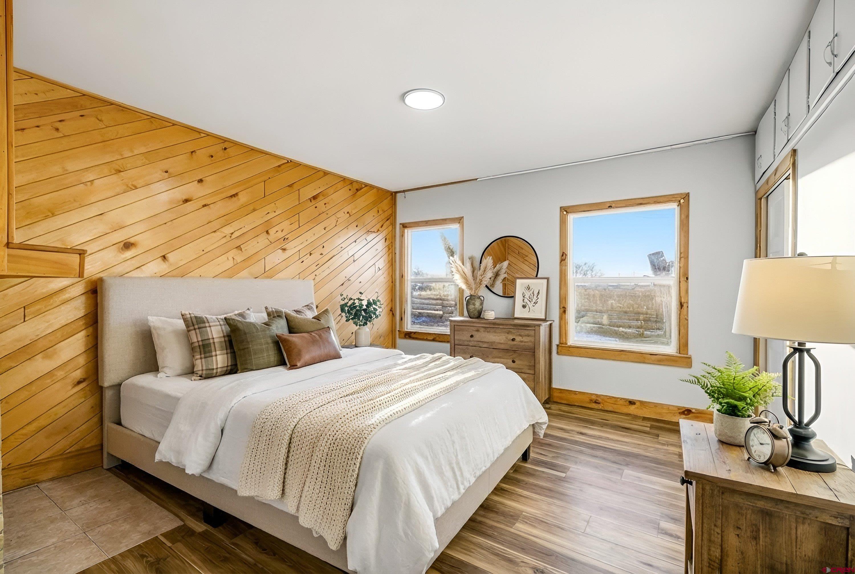 6038 Townsend Road Delta, CO 81416 - Photo 32 of 45 a bedroom with a bed and a large window