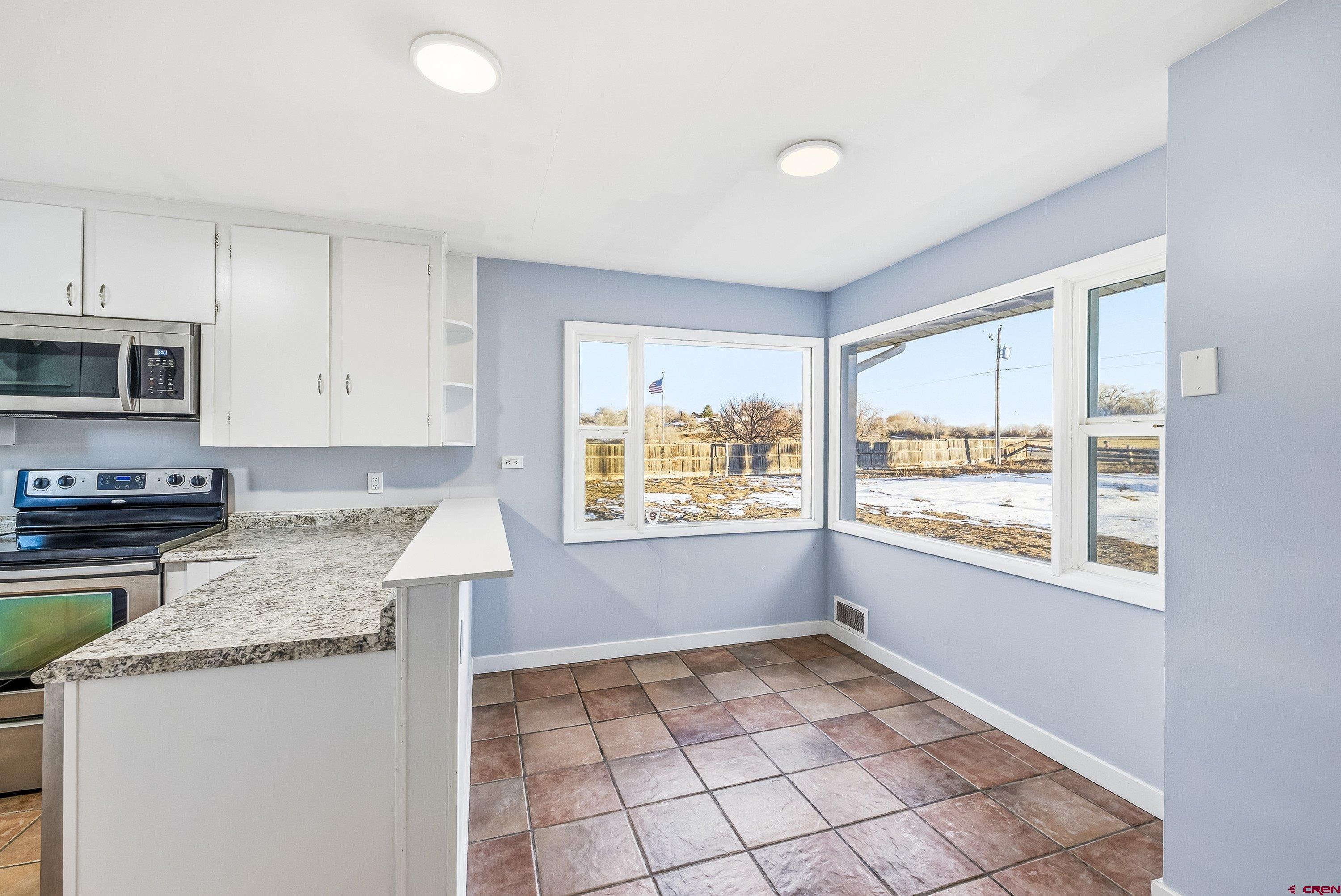 6038 Townsend Road Delta, CO 81416 - Photo 44 of 45 a kitchen with granite countertop a stove a sink and a granite counter tops