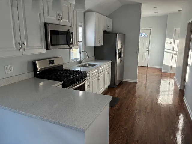 a kitchen with stainless steel appliances a refrigerator stove and microwave