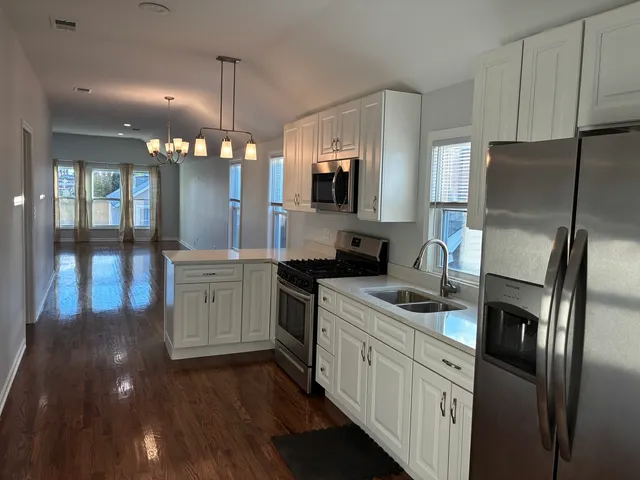 a kitchen with stainless steel appliances a refrigerator sink and cabinets