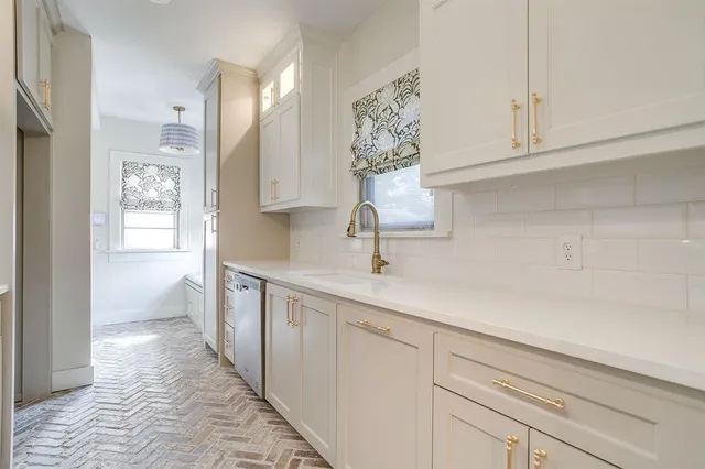 a kitchen with a sink and cabinets