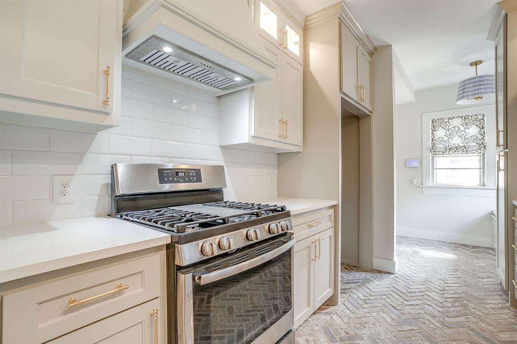 2209 West Rosedale Street South Fort Worth, TX 76110 - Photo 17 of 40 a kitchen with granite countertop a stove and a refrigerator