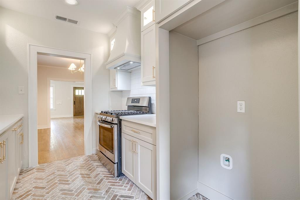 2209 West Rosedale Street South Fort Worth, TX 76110 - Photo 18 of 40 a kitchen with stainless steel appliances granite countertop a refrigerator and a sink