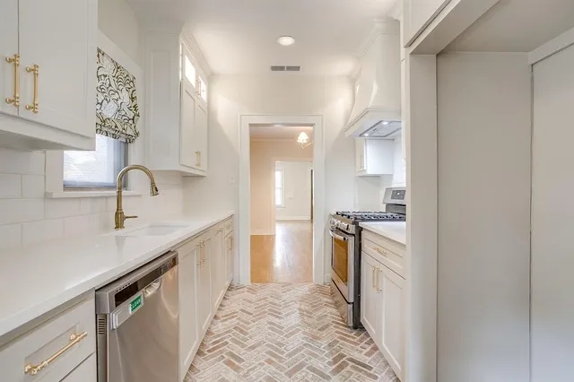 a kitchen with a sink stove and refrigerator