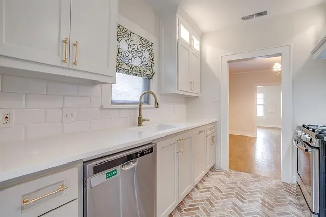 a kitchen with a sink and cabinets
