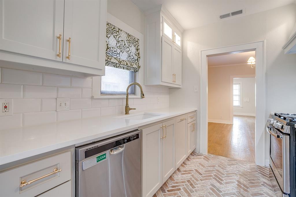 2209 West Rosedale Street South Fort Worth, TX 76110 - Photo 20 of 40 a kitchen with a sink and cabinets