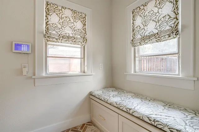 a room with a granite countertop sink and window