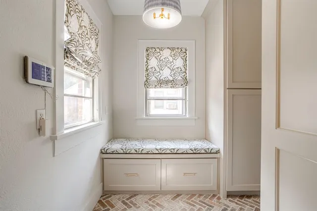 a bathroom with a granite countertop sink and a window