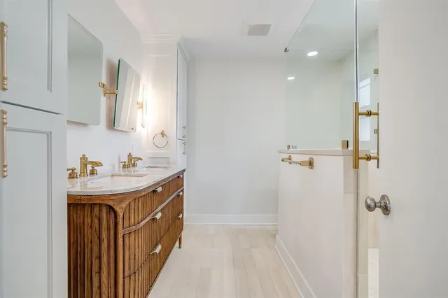 a bathroom with a sink a mirror and a shower