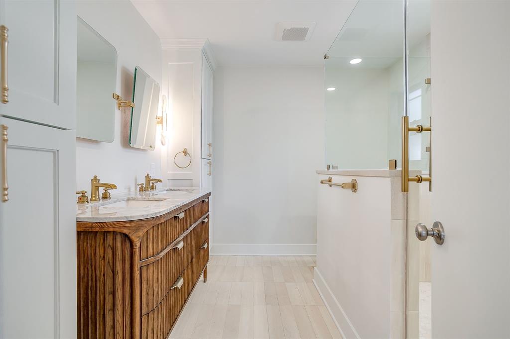 2209 West Rosedale Street South Fort Worth, TX 76110 - Photo 27 of 40 a bathroom with a sink a mirror and a shower