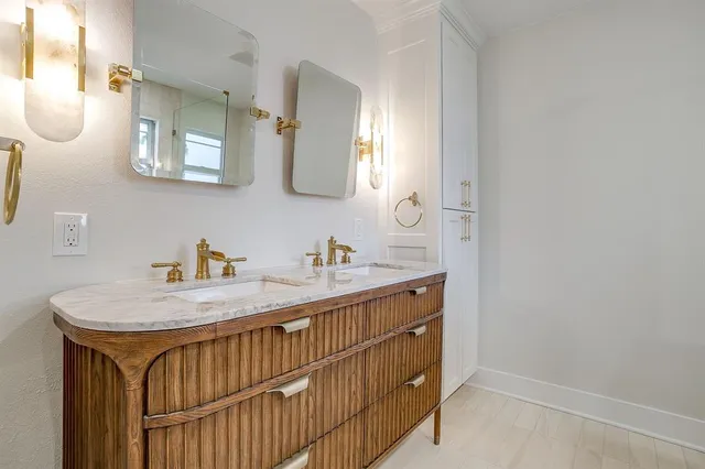 a bathroom with a sink a vanity and a mirror