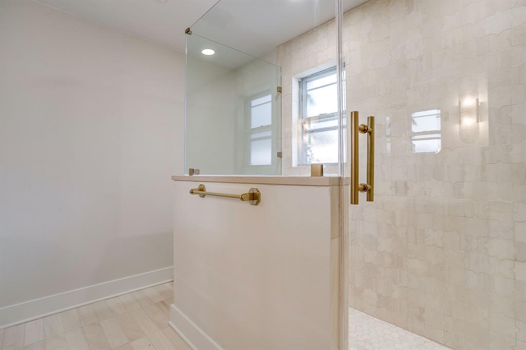 2209 West Rosedale Street South Fort Worth, TX 76110 - Photo 31 of 40 a bathroom with a window shower and sink