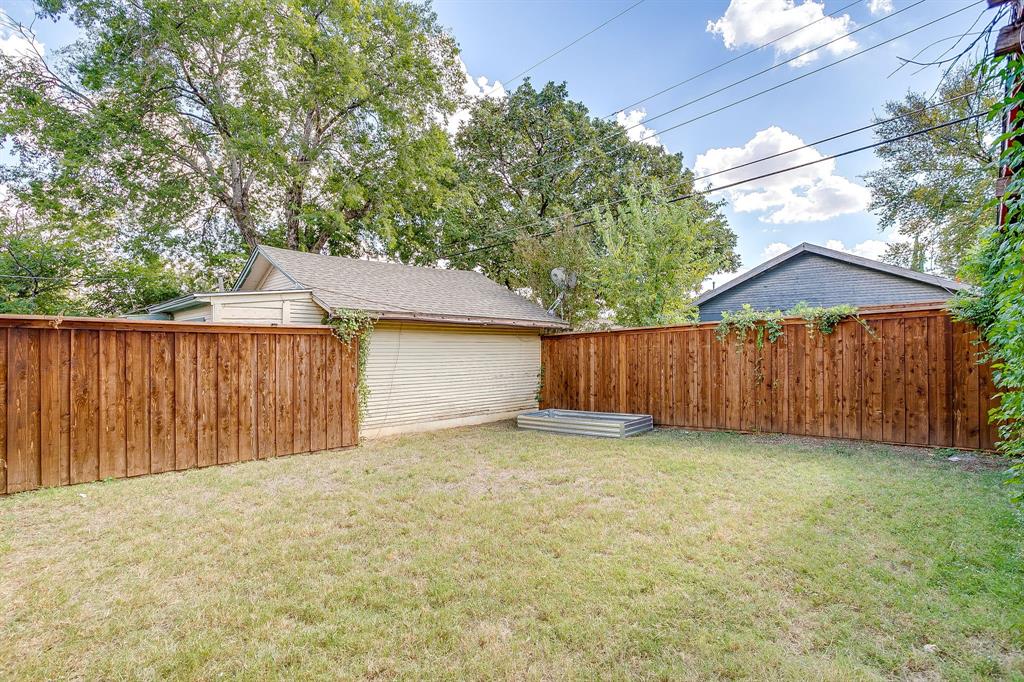 2209 West Rosedale Street South Fort Worth, TX 76110 - Photo 40 of 40 a view of a backyard with wooden fence