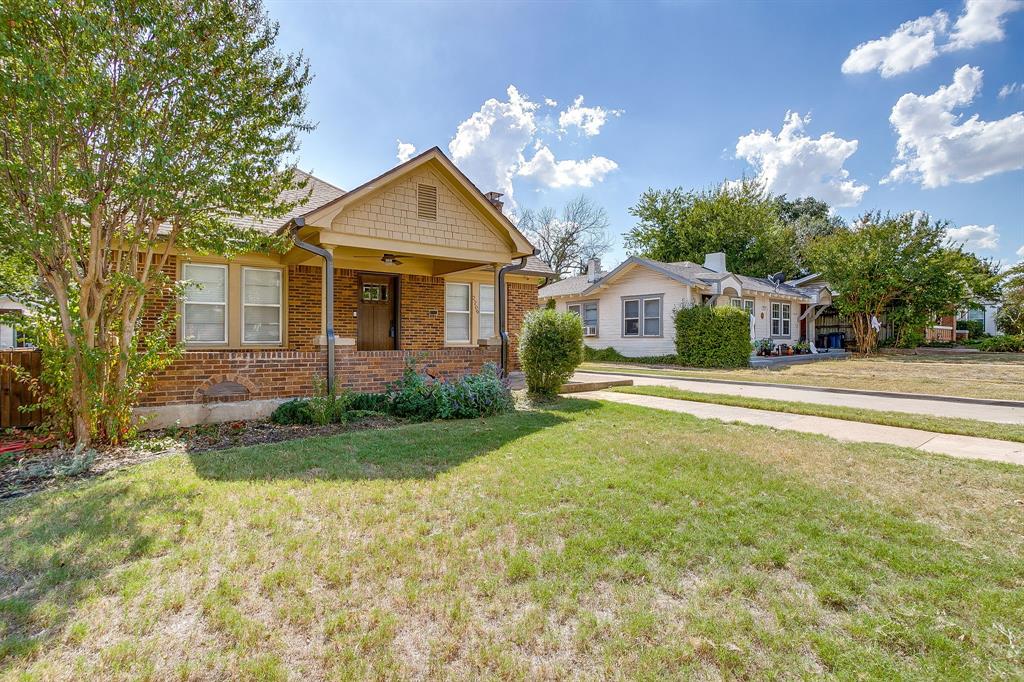 2209 West Rosedale Street South Fort Worth, TX 76110 - Photo 4 of 40 a front view of a house with garden