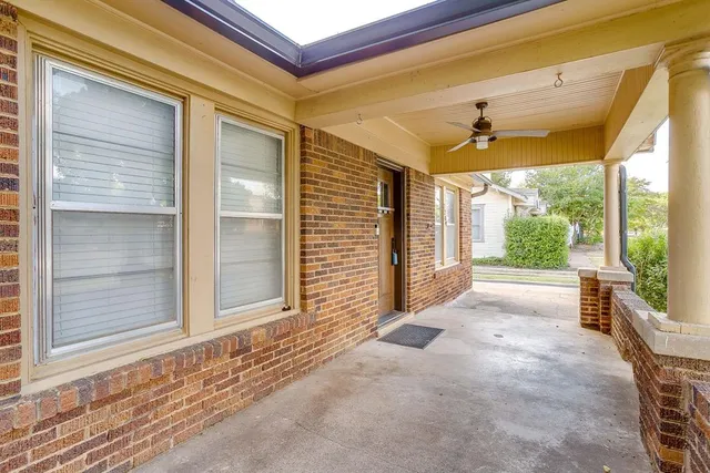 a view of a porch with a table and chairs