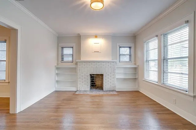 a view of a livingroom with a fireplace and window