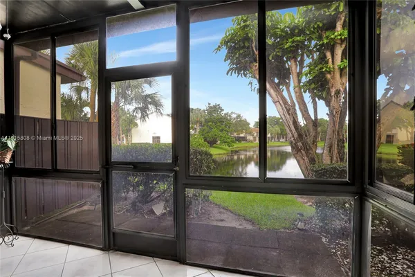 a view of a porch with a floor to ceiling window wooden floor