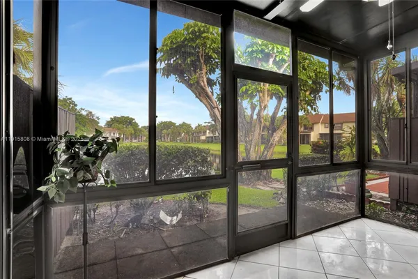 a view of a porch with a floor to ceiling window and outside view