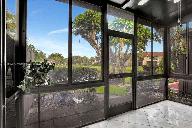 a view of a porch with a floor to ceiling window and outside view