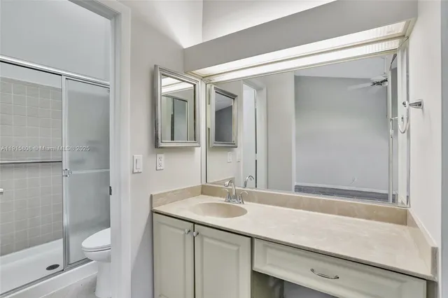 a bathroom with a sink shower and a mirror