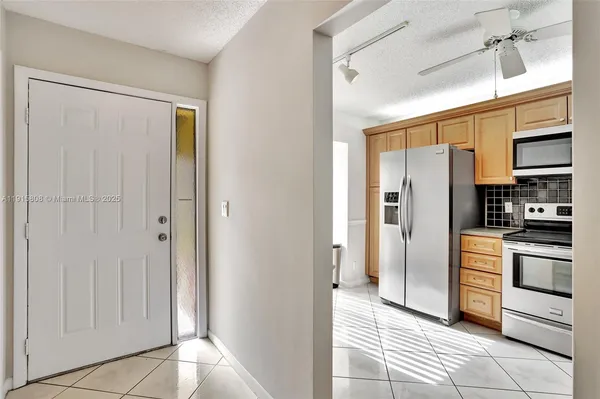 a kitchen with stainless steel appliances a refrigerator and cabinets