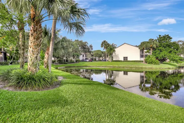 a view of a garden with a building in the background