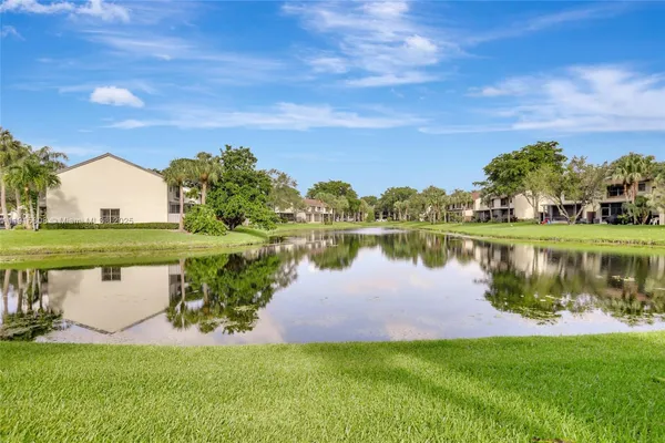 a view of a lake with houses in the background