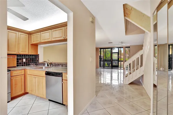 a kitchen with white cabinets and white appliances