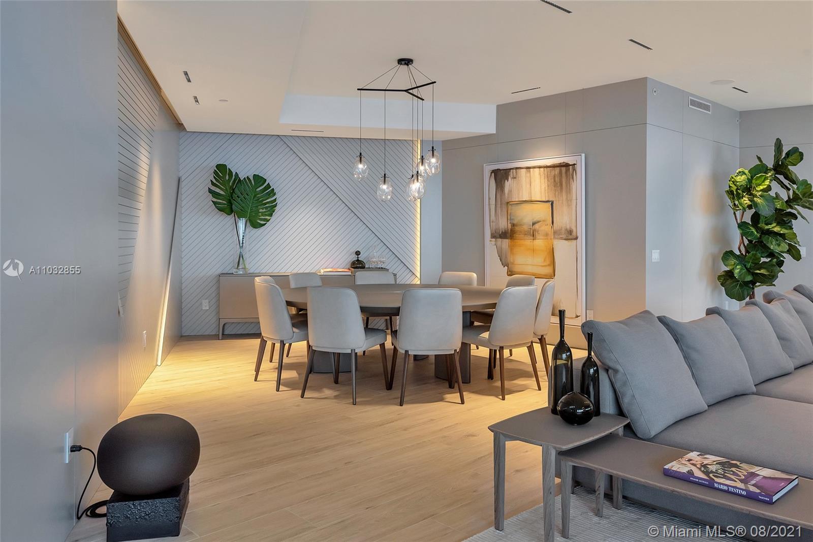 North Biscayne Beach Sunny Isles Beach, FL 33160 - Photo 11 of 52 a living room with furniture a chandelier and a dining table