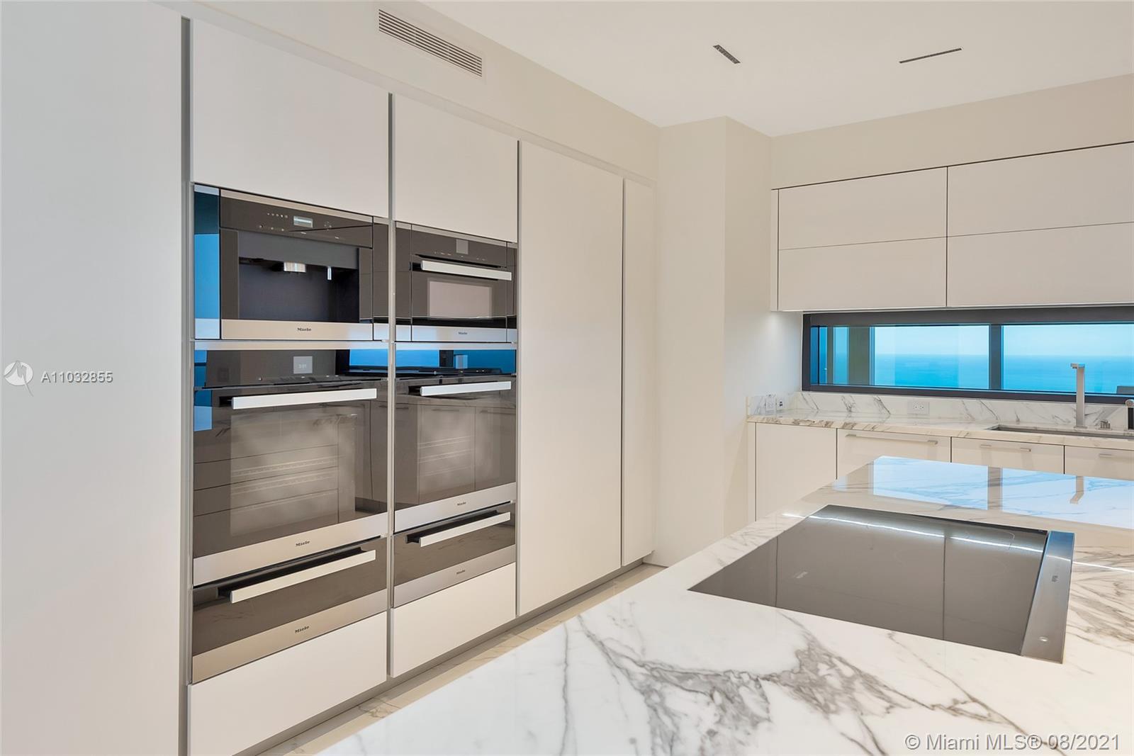 North Biscayne Beach Sunny Isles Beach, FL 33160 - Photo 18 of 52 a kitchen with a refrigerator and a stove top oven