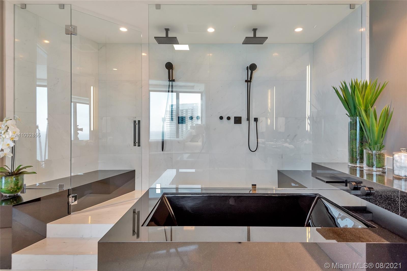 North Biscayne Beach Sunny Isles Beach, FL 33160 - Photo 23 of 52 a large kitchen with kitchen island a counter top space a sink stainless steel appliances and cabinets