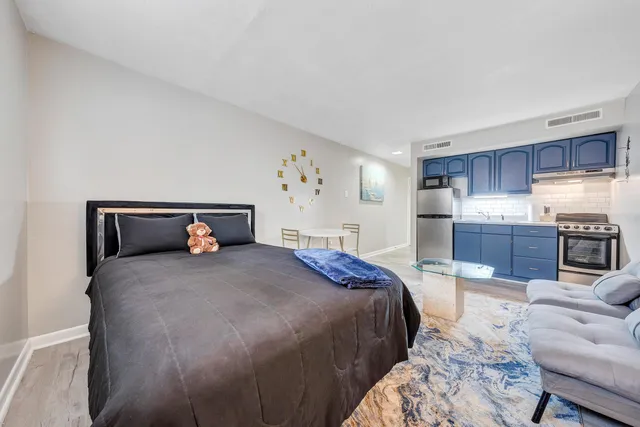 a bedroom with a bed and wooden floor