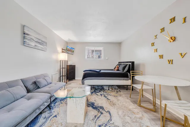 a living room with furniture and a dining table