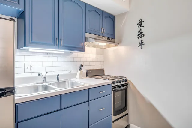 a kitchen with a sink and cabinets