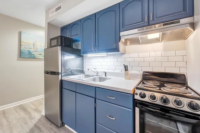 a kitchen with a stove and a refrigerator