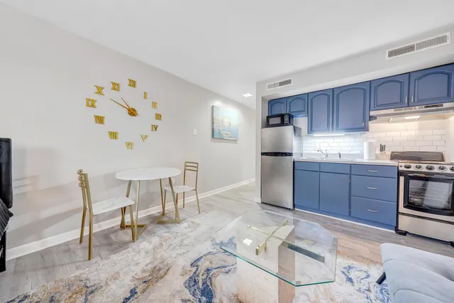 a kitchen with granite countertop wooden cabinets and stainless steel appliances