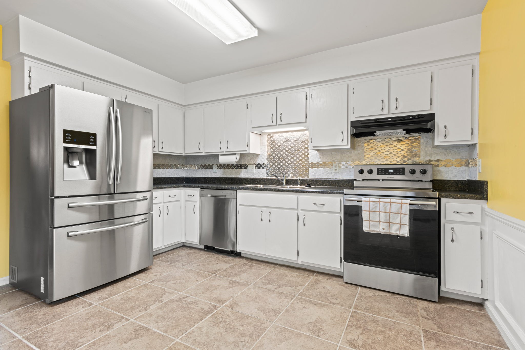 722 Kent Road Nashville, TN 37214 - Photo 10 of 17 a kitchen with granite countertop white cabinets and stainless steel appliances
