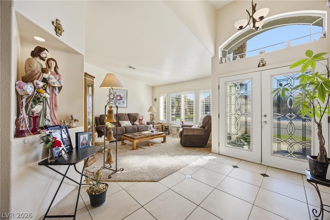 6109 Ocho Rios Street Las Vegas, NV 89130 - Photo 17 of 36 Entrance foyer featuring french doors, a high ceiling, and light tile patterned flooring